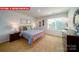 Bright bedroom with a large window, soft carpet, and orange metal bed at 11128 Cardinal Creek Ave, Charlotte, NC 28215