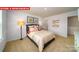 Comfortable bedroom features soft carpet, natural light, and contemporary decor at 11128 Cardinal Creek Ave, Charlotte, NC 28215
