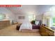 Comfortable bedroom showcasing tufted headboard, accent pillows and an upholstered ottoman at 11128 Cardinal Creek Ave, Charlotte, NC 28215