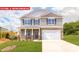 Charming two-story home with stone accents, a two-car garage, and a well-manicured lawn at 11128 Cardinal Creek Ave, Charlotte, NC 28215