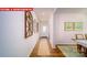 Inviting hallway with hardwood floors, decorative wall art, and a view of the front door at 11128 Cardinal Creek Ave, Charlotte, NC 28215