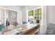 Sun-drenched home office with a large window, spacious desk, and white french doors, creating a bright workspace at 11128 Cardinal Creek Ave, Charlotte, NC 28215
