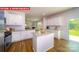 Bright kitchen featuring an island, ample cabinet space, and hardwood flooring at 11128 Cardinal Creek Ave, Charlotte, NC 28215