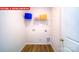 Practical laundry room with wood-look floors and a wire shelf at 11128 Cardinal Creek Ave, Charlotte, NC 28215