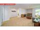 Spacious living room showcasing carpeted floors and a glimpse into another bedroom at 11128 Cardinal Creek Ave, Charlotte, NC 28215