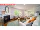 Comfortable living room with a fireplace, cozy armchairs, and an adjacent white kitchen, perfect for entertaining at 11128 Cardinal Creek Ave, Charlotte, NC 28215