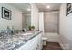 Bathroom featuring granite countertops, white cabinets, a sink, a toilet, and a tiled shower/bath at 112 Tanner Loop, Troutman, NC 28166