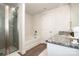 Well-lit bathroom features granite countertops, a shower and tub combination, and white cabinets at 112 Tanner Loop, Troutman, NC 28166