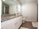 Bathroom with white cabinets, a gray granite countertop, a shower and a toilet at 112 Tanner Loop, Troutman, NC 28166