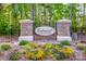 Entrance to Colonial Crossing features stone pillars, iron gate, and landscaping at 112 Tanner Loop, Troutman, NC 28166
