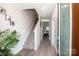 Bright entryway with wood floors leading to stairs and an open doorway, with neutral walls and white trim at 112 Tanner Loop, Troutman, NC 28166
