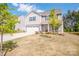 Charming two-story home with gray siding, a two-car garage, well-manicured lawn and freshly landscaped flowerbeds at 112 Tanner Loop, Troutman, NC 28166