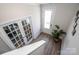 Bright hallway features wood-look flooring, office with glass doors, and front door with glass window pane at 112 Tanner Loop, Troutman, NC 28166