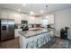 Modern kitchen with stainless steel appliances, granite countertops, white cabinets, and seating at the kitchen island at 112 Tanner Loop, Troutman, NC 28166
