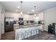 Spacious kitchen featuring granite countertops, stainless steel appliances, and a large island with seating at 112 Tanner Loop, Troutman, NC 28166