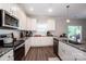 Well-lit kitchen featuring granite countertops, stainless steel appliances, and white cabinets at 112 Tanner Loop, Troutman, NC 28166