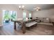 Open concept living room and dining area with a large glass door leading to outdoor patio at 112 Tanner Loop, Troutman, NC 28166