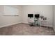 A small office area with carpet, a white board, desk with two monitors and a chair at 112 Tanner Loop, Troutman, NC 28166