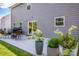 View of backyard patio with grill, table and chairs, and gray siding at 112 Tanner Loop, Troutman, NC 28166
