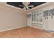 Bright bedroom boasts a ceiling fan, wood floors, and large windows with decorative curtains at 1142 Ardwyck Pl # 5, Rock Hill, SC 29730