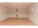 Empty dining room features a chandelier, and paneled walls at 1142 Ardwyck Pl # 5, Rock Hill, SC 29730