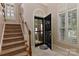 Inviting foyer with tile flooring, staircase, and an open door, offering a welcoming entrance at 1142 Ardwyck Pl # 5, Rock Hill, SC 29730