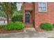 Charming brick home featuring a classic black front door with landscaped greenery at 1142 Ardwyck Pl # 5, Rock Hill, SC 29730