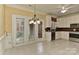 Bright kitchen area with white cabinets, tiled flooring, and views to the backyard at 1142 Ardwyck Pl # 5, Rock Hill, SC 29730