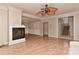 Bright living room with a fireplace, light wood floors, crown molding, and a decorative ceiling fan at 1142 Ardwyck Pl # 5, Rock Hill, SC 29730