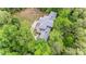 Serene aerial view of a private home nestled among dense trees with a spacious deck at 115 Forestcliff Ne Ct, Concord, NC 28025