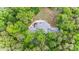 Picturesque aerial view of a house with a well-manicured lawn and surrounded by lush greenery at 115 Forestcliff Ne Ct, Concord, NC 28025