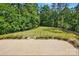 Spacious backyard featuring lush lawn and brick patio perfect for outdoor living at 115 Forestcliff Ne Ct, Concord, NC 28025