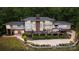 Expansive home exterior with brick accents, a multi-level deck, mature landscaping, and patio seating perfect for outdoor entertaining at 115 Forestcliff Ne Ct, Concord, NC 28025