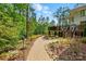 Beautiful landscaped backyard with winding stone pathway leading to deck at 115 Forestcliff Ne Ct, Concord, NC 28025