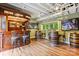 Basement bar area with custom wood bar and wine barrel tables at 115 Forestcliff Ne Ct, Concord, NC 28025