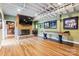 Finished basement with brick fireplace, shuffleboard, and bar area at 115 Forestcliff Ne Ct, Concord, NC 28025
