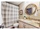Cozy bathroom featuring a granite countertop, framed mirror, and shower at 115 Forestcliff Ne Ct, Concord, NC 28025