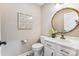 Elegant powder room features custom mirror, decor and modern fixtures at 115 Forestcliff Ne Ct, Concord, NC 28025