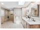 Bright bathroom featuring double sinks, a glass shower with seating, and elegant fixtures at 115 Forestcliff Ne Ct, Concord, NC 28025