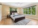 Comfortable bedroom featuring a dark wood bed, large windows, and a ceiling fan at 115 Forestcliff Ne Ct, Concord, NC 28025