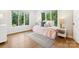 Cozy bedroom featuring natural light from two windows and stylish decor with fresh neutral colors at 115 Forestcliff Ne Ct, Concord, NC 28025