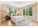 Bright bedroom with large windows, neutral walls, and a plush white bed at 115 Forestcliff Ne Ct, Concord, NC 28025