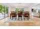 Bright dining room with elegant chandelier, large windows, and a sliding glass door to outdoor seating at 115 Forestcliff Ne Ct, Concord, NC 28025
