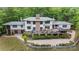 Beautiful aerial view of a well-maintained home with a spacious deck and lush landscaping at 115 Forestcliff Ne Ct, Concord, NC 28025