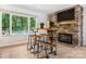 This inviting living room boasts a cozy stone fireplace and a custom bar table with wooden stools at 115 Forestcliff Ne Ct, Concord, NC 28025