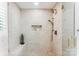 Walk-in shower featuring a built-in seat, decorative niche, and elegant bronze fixtures at 115 Forestcliff Ne Ct, Concord, NC 28025