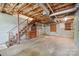 Spacious unfinished basement with stairs, exposed ductwork, and concrete walls at 1205 Southwood Dr, Newton, NC 28658