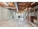 Unfinished basement with stairs, wood ceilings, and a garage door at 1205 Southwood Dr, Newton, NC 28658
