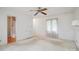 Bedroom with neutral carpeting and paint features a ceiling fan, window, and bathroom access at 1205 Southwood Dr, Newton, NC 28658