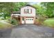 Two-story home featuring attached garage, upper level and a lush green surroundings at 1205 Southwood Dr, Newton, NC 28658